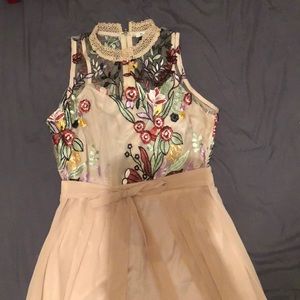 Embroidered romper with chiffon cape.